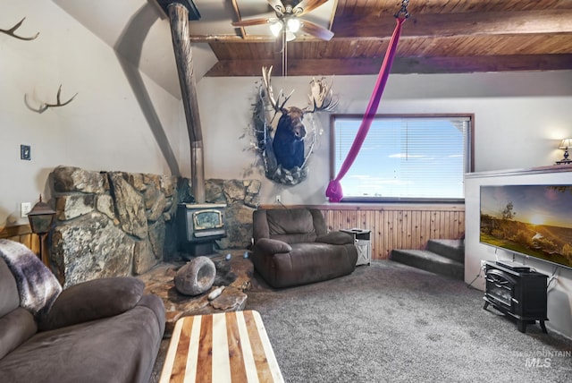 1011 E 1000 S, Albion, ID 83311 - living area featuring a wood stove, wood ceiling with exposed beams, carpet, ceiling fan, and wooden walls