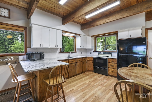 1011 E 1000 S, Albion, ID 83311 - kitchen with black appliances, wood ceiling with exposed beams, a sink, a peninsula, and light wood-type flooring