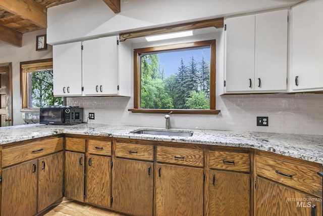 1011 E 1000 S, Albion, ID 83311 - kitchen with a sink, tasteful backsplash, light stone countertops, and white cabinets