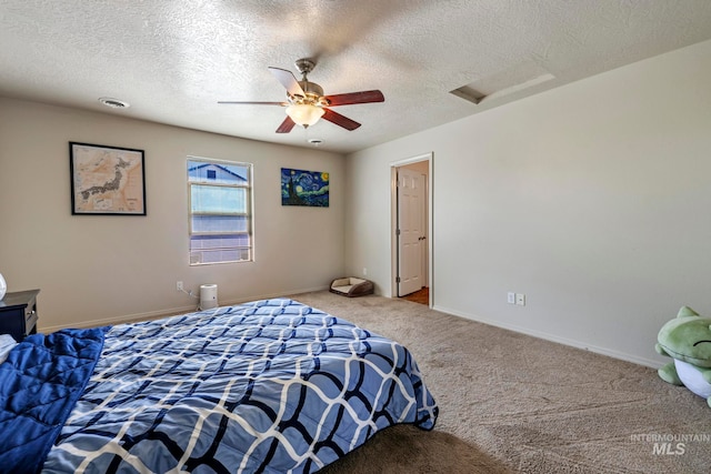 carpeted bedroom featuring ceiling fan and a textured ceiling