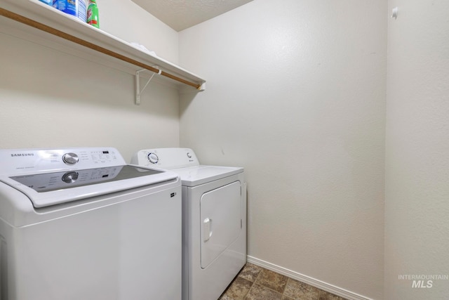 laundry room with washing machine and clothes dryer