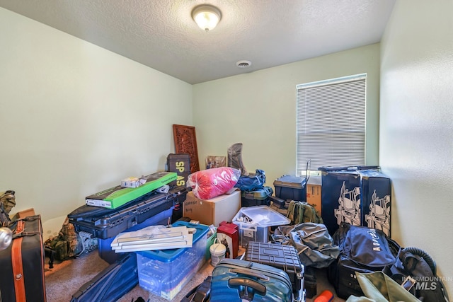 miscellaneous room with a textured ceiling