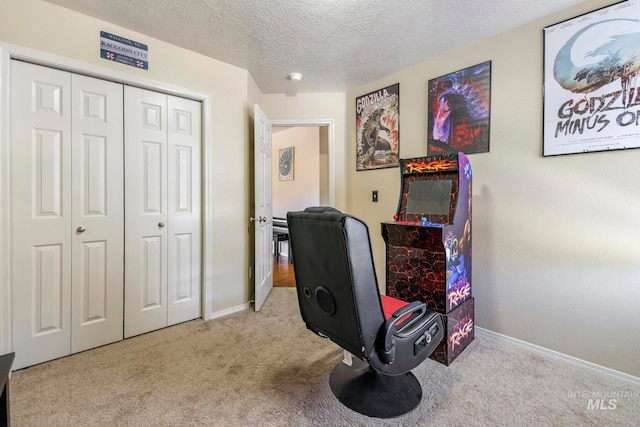 home office with light carpet and a textured ceiling