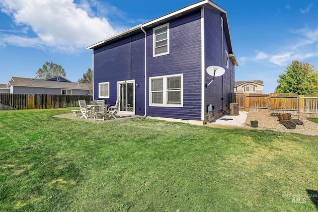 back of house featuring a yard, a patio, and central AC