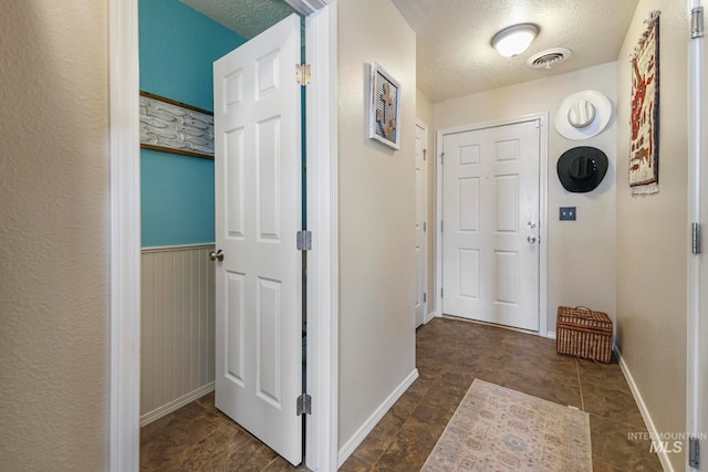 hallway with a textured ceiling