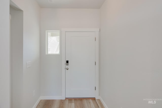 entryway with baseboards and light wood-type flooring