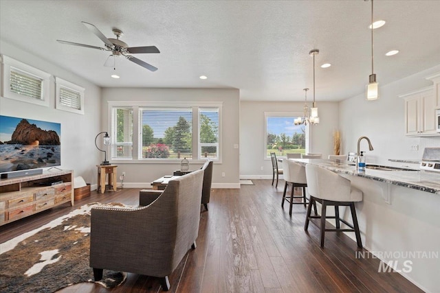 9753 W Wildbranch, Star, ID 83669 - living area featuring dark wood-type flooring, ceiling fan, recessed lighting, and a chandelier