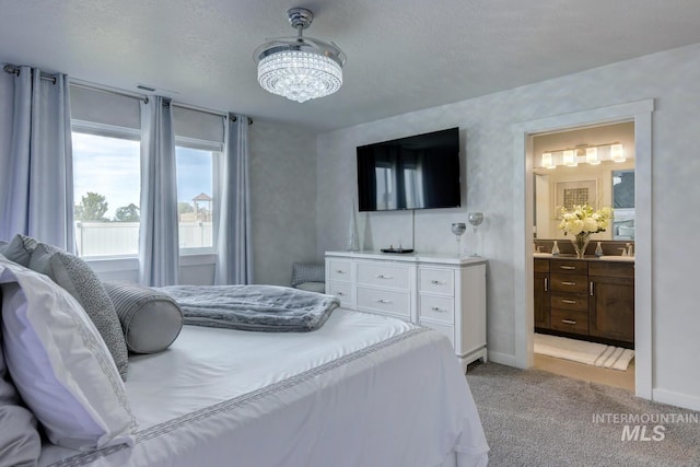 1987 S Defio Way, Meridian, ID 83642 - bedroom featuring a chandelier, light colored carpet, and connected bathroom