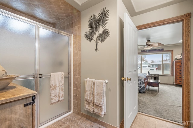 bathroom featuring ceiling fan, tile patterned flooring, vanity, and walk in shower