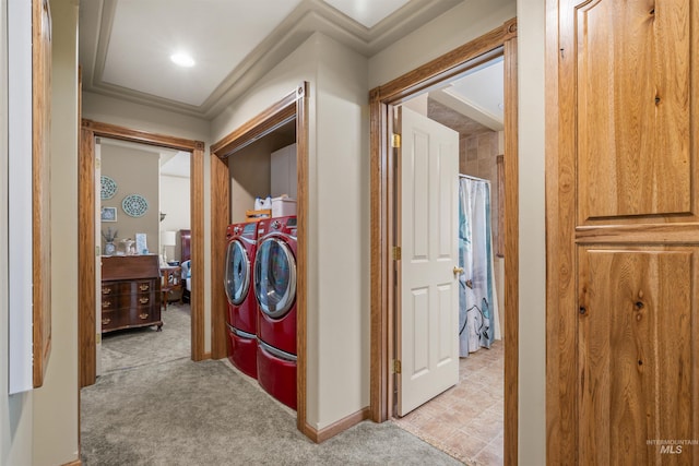 hallway featuring light carpet, separate washer and dryer, and crown molding