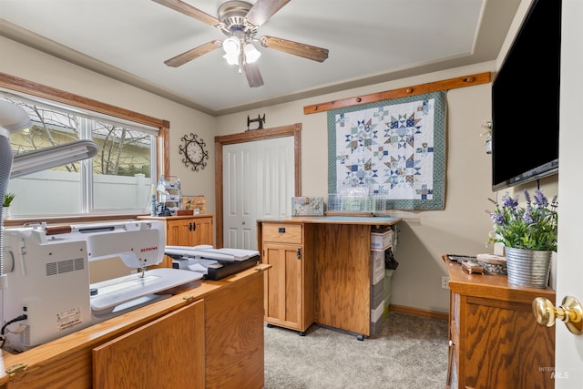 home office with light carpet and ceiling fan