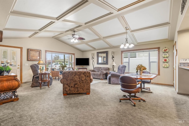 carpeted living room with ceiling fan with notable chandelier and vaulted ceiling