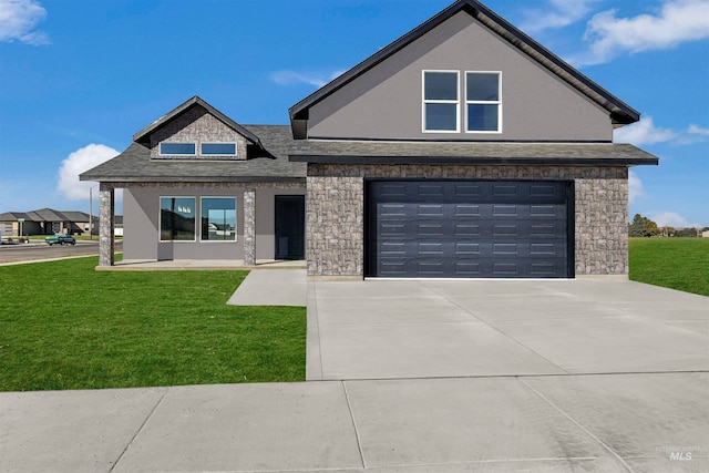 view of front of property featuring a garage and a front yard