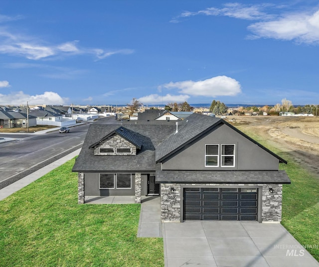 view of front facade featuring driveway, a front yard, an attached garage, stone siding, and stucco siding