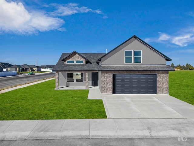 view of front of property with a garage and a front lawn