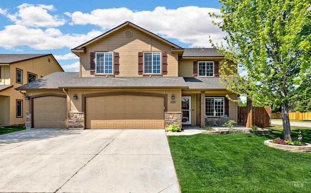 5375 N Isla Ave, Meridian, ID 83646 - traditional-style house featuring concrete driveway, stone siding, a shingled roof, and a garage