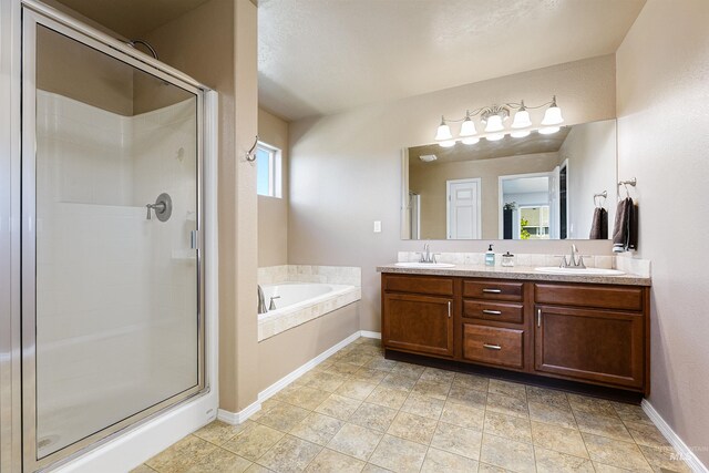 5375 N Isla Ave, Meridian, ID 83646 - bathroom featuring a stall shower, double vanity, a bath, and baseboards