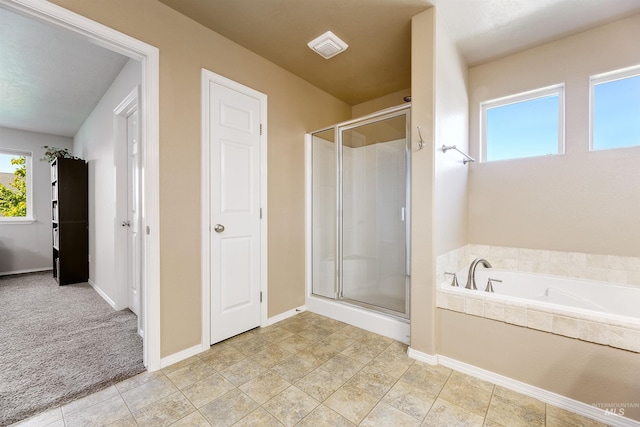 5375 N Isla Ave, Meridian, ID 83646 - bathroom featuring a shower stall, a bath, and baseboards