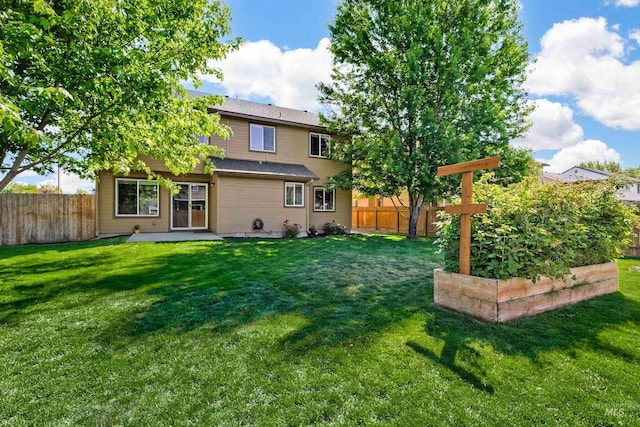 5375 N Isla Ave, Meridian, ID 83646 - rear view of house featuring a vegetable garden and a patio area