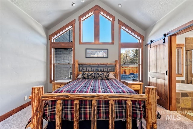 carpeted bedroom featuring vaulted ceiling, a barn door, and a textured ceiling