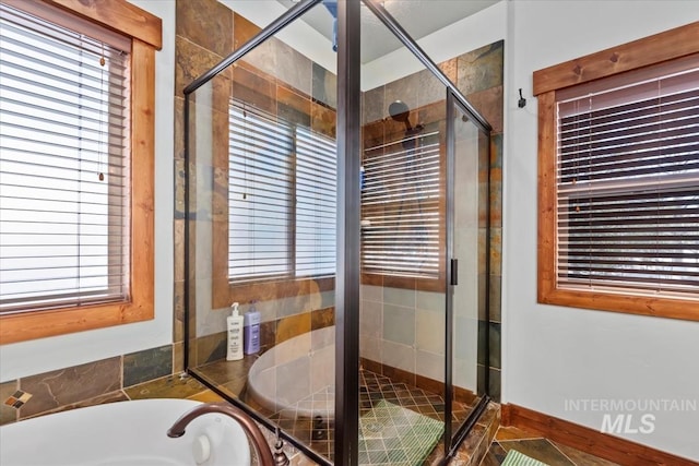 bathroom with plenty of natural light and shower with separate bathtub