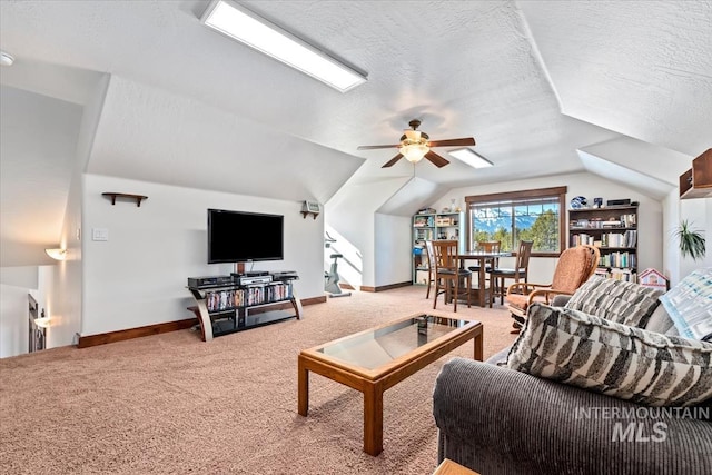 carpeted living room featuring ceiling fan, lofted ceiling, and a textured ceiling