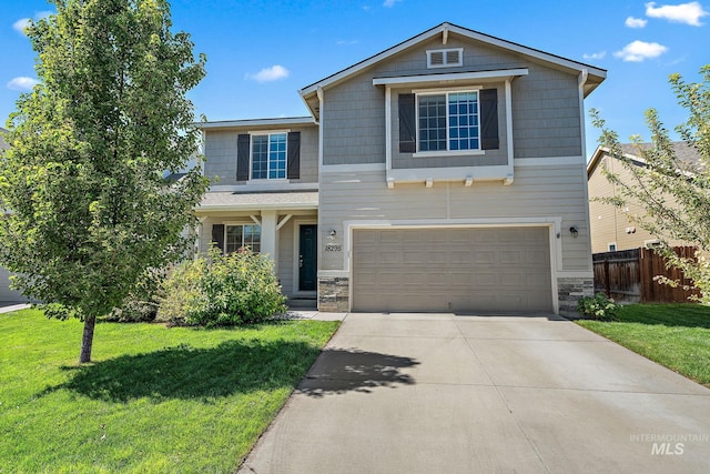 craftsman inspired home featuring a garage and a front lawn