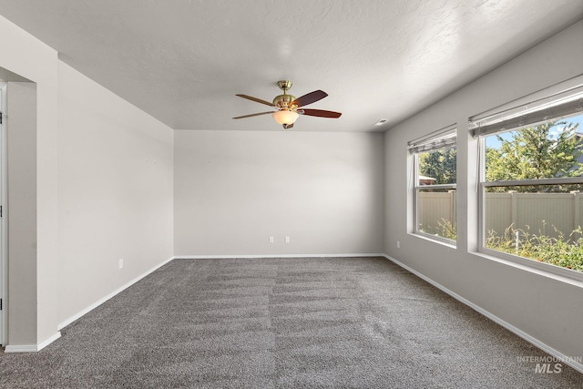 spare room with ceiling fan and carpet floors