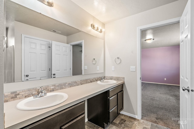 bathroom featuring tile patterned flooring, tasteful backsplash, and vanity