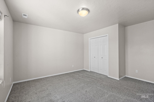 unfurnished bedroom with carpet and a closet