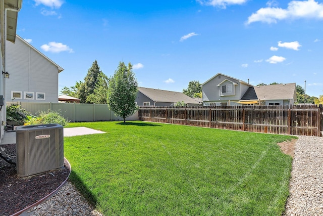 view of yard with central AC and a patio