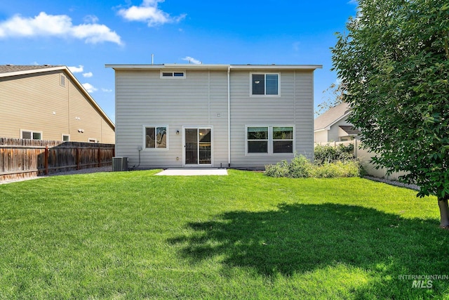 back of property with central AC, a lawn, and a patio