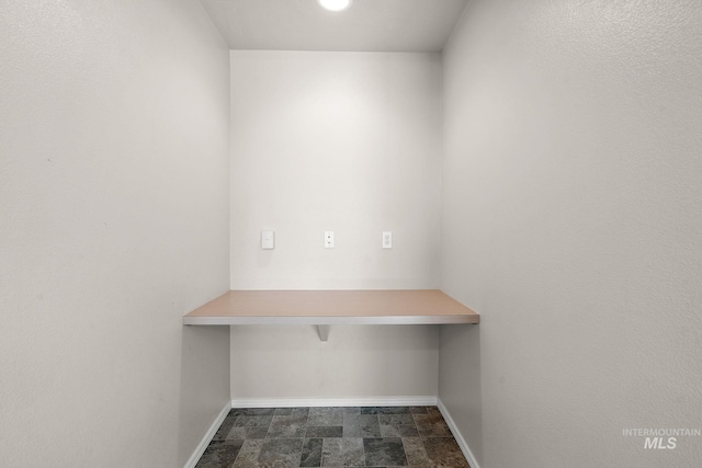 unfurnished office with dark tile patterned floors