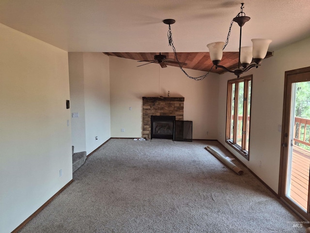8 Lookout Rd, Garden Valley, ID 83622 - unfurnished living room featuring carpet flooring, a stone fireplace, a ceiling fan, vaulted ceiling, and baseboards