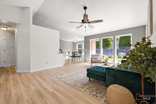 512 S Pelican Way, Meridian, ID 83642 - living area featuring light wood-style flooring, ceiling fan, and baseboards