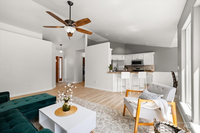 512 S Pelican Way, Meridian, ID 83642 - living room with ceiling fan, light wood-type flooring, baseboards, and high vaulted ceiling