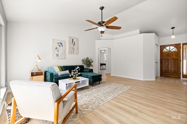 512 S Pelican Way, Meridian, ID 83642 - living area featuring ceiling fan, arched walkways, light wood-style floors, lofted ceiling, and healthy amount of natural light