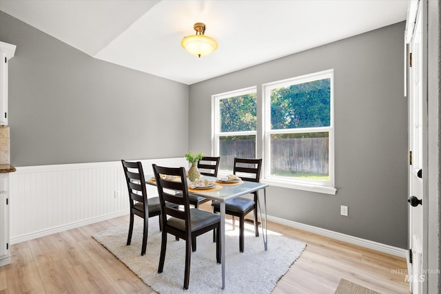 512 S Pelican Way, Meridian, ID 83642 - dining area with light wood-style flooring, baseboards, and a wainscoted wall