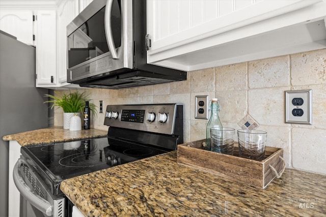 512 S Pelican Way, Meridian, ID 83642 - kitchen with appliances with stainless steel finishes, white cabinetry, backsplash, and dark stone counters