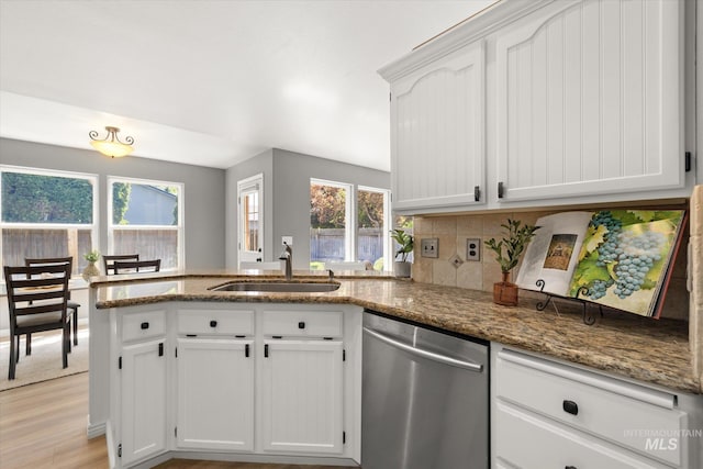 512 S Pelican Way, Meridian, ID 83642 - kitchen with dishwasher, a sink, a peninsula, stone countertops, and white cabinetry