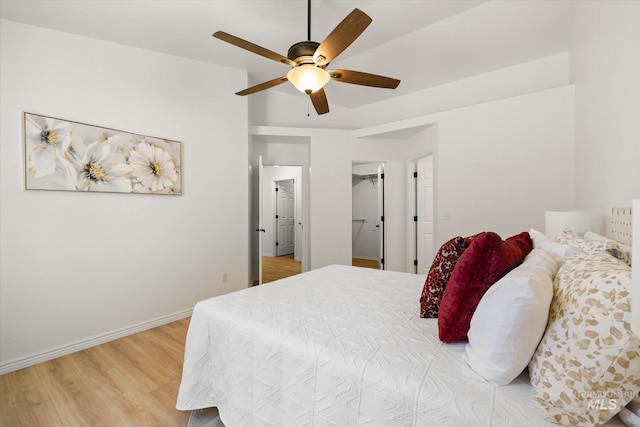 512 S Pelican Way, Meridian, ID 83642 - bedroom with light wood-style flooring, baseboards, a ceiling fan, and a spacious closet