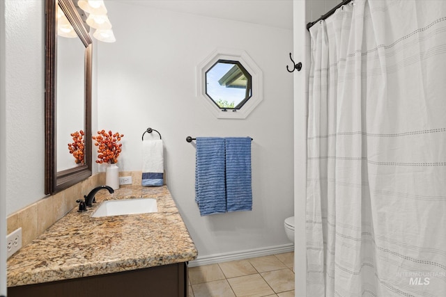 512 S Pelican Way, Meridian, ID 83642 - full bath with vanity, toilet, tile patterned floors, and baseboards
