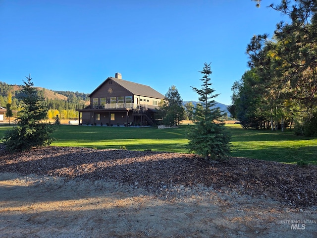 3779 N Rawah Dr, Featherville, ID 83647 - view of green lawn featuring stairway and a deck