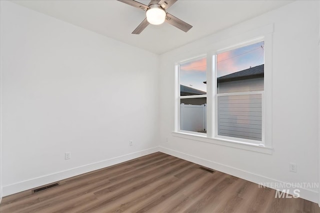 unfurnished room with ceiling fan and hardwood / wood-style floors