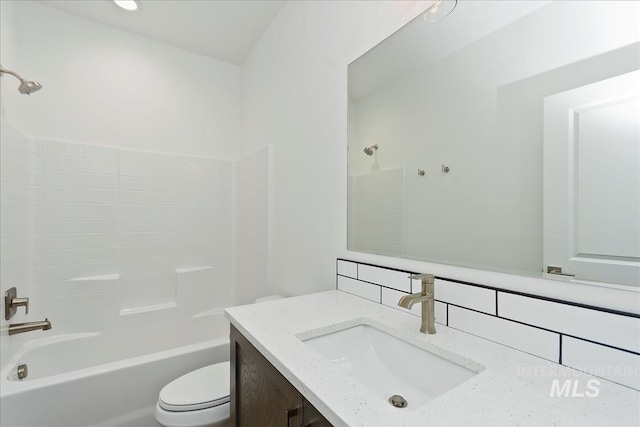 full bathroom with vanity, decorative backsplash,  shower combination, and toilet