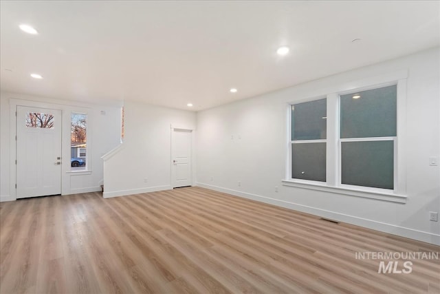 unfurnished living room with light wood-type flooring