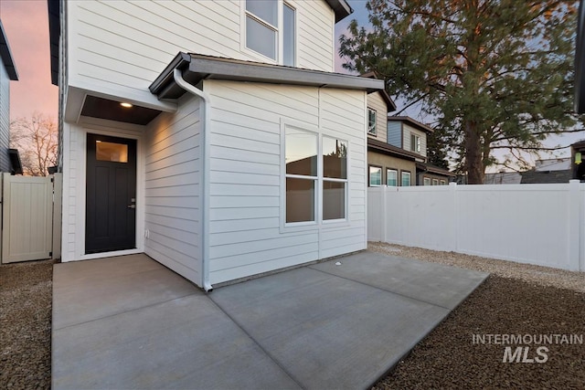 property entrance featuring a patio area