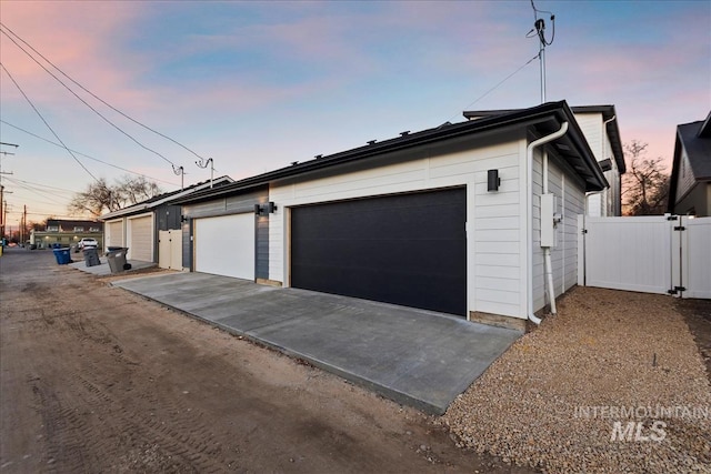 view of garage at dusk