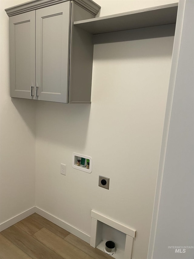 laundry room with laundry area, electric dryer hookup, wood finished floors, baseboards, and hookup for a washing machine