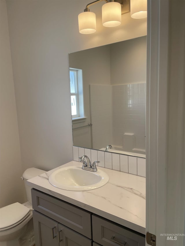 bathroom with toilet and vanity